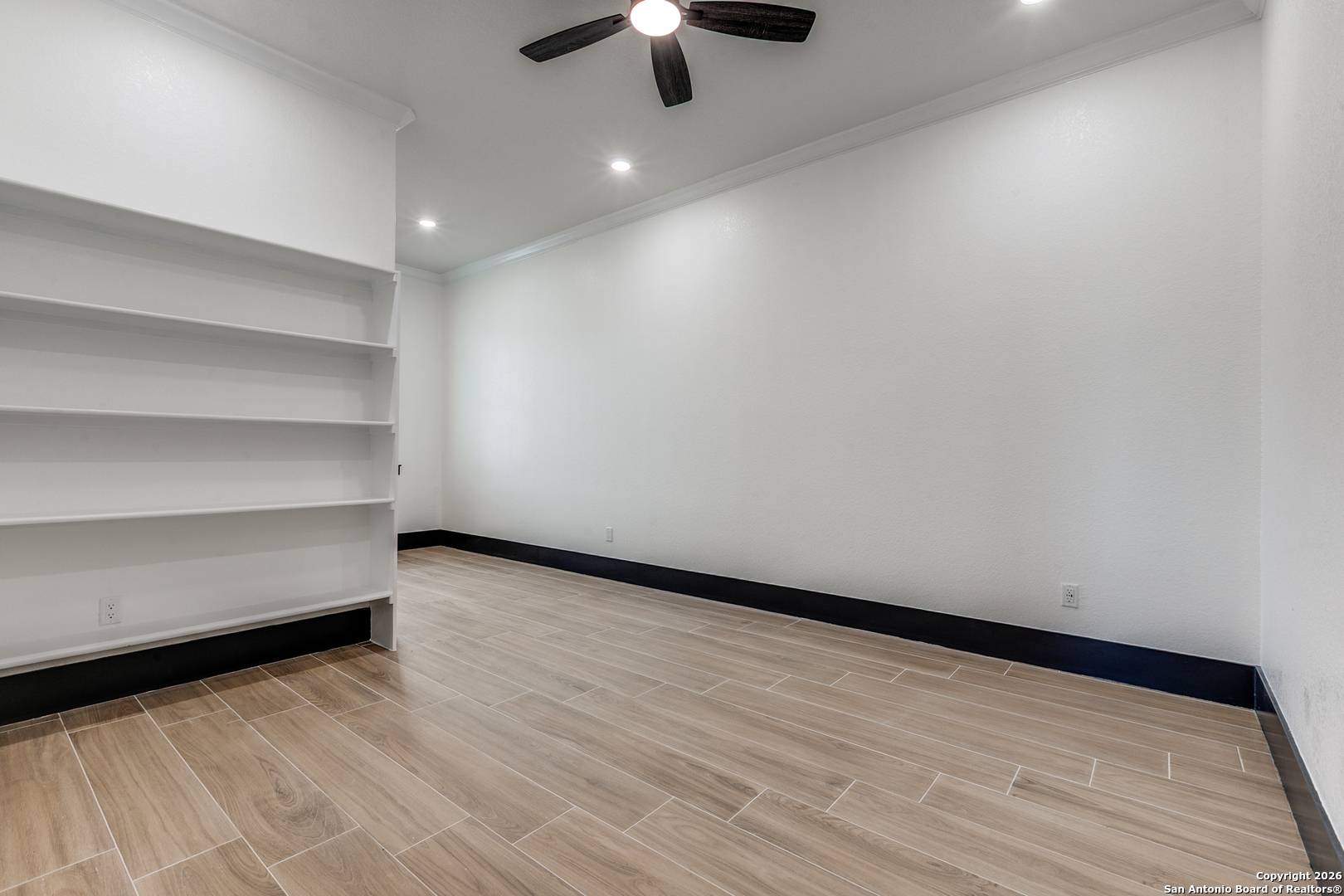 202 Venado Oaks Rio Medina, TX 78066 - Photo 25 of 37 a view of an empty room with a ceiling fan and wooden floor