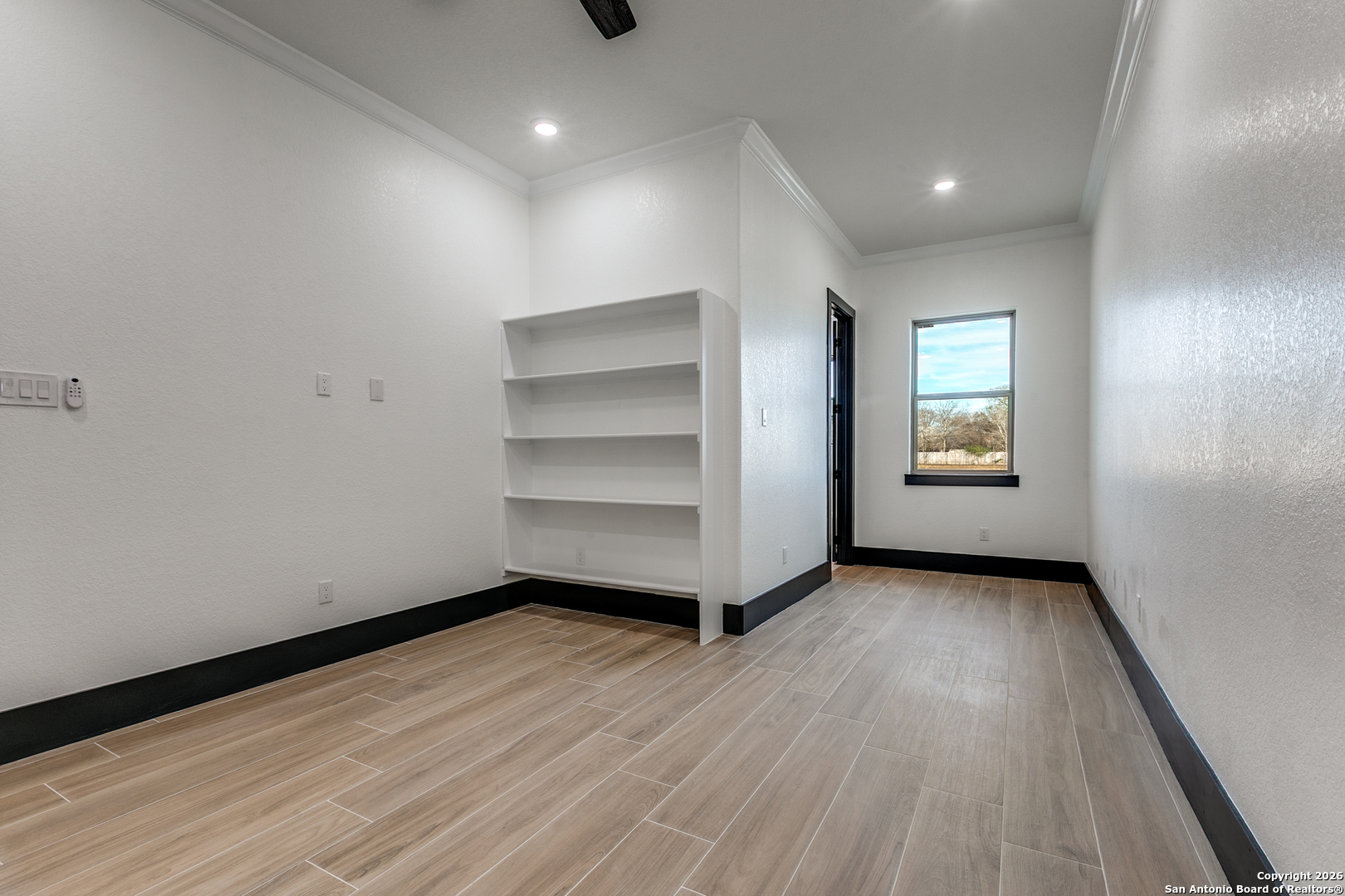202 Venado Oaks Rio Medina, TX 78066 - Photo 26 of 37 a view of an empty room with a window and wooden floor