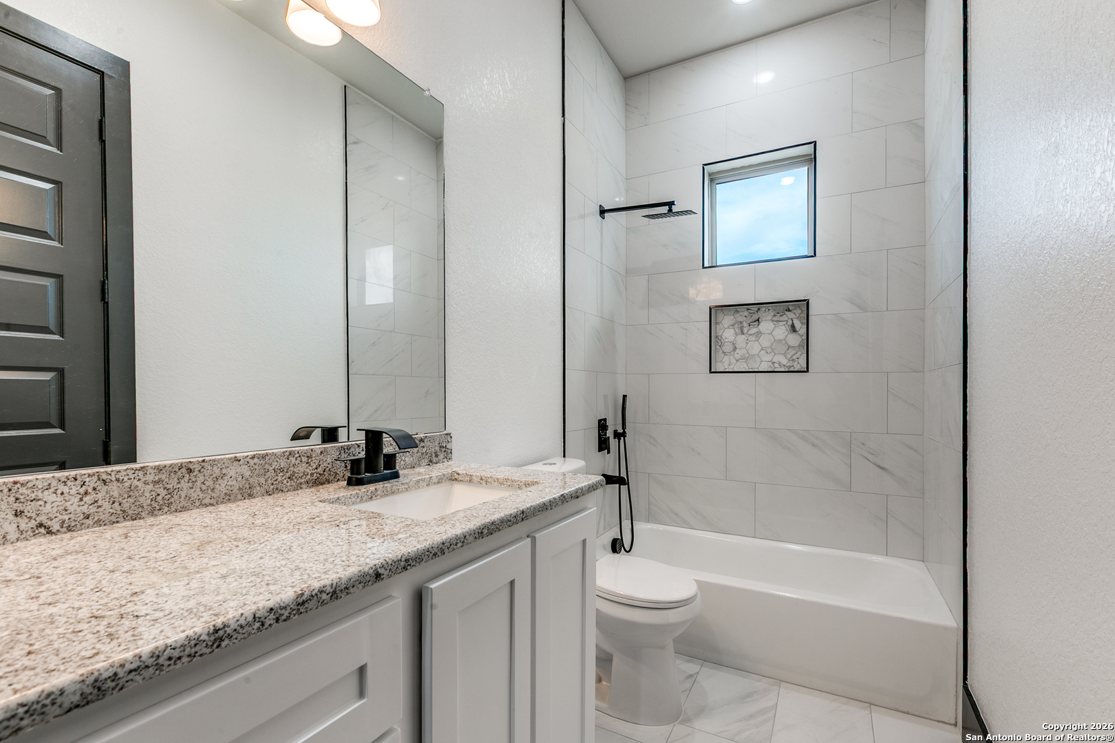 202 Venado Oaks Rio Medina, TX 78066 - Photo 28 of 37 a bathroom with a granite countertop sink a toilet and bathtub