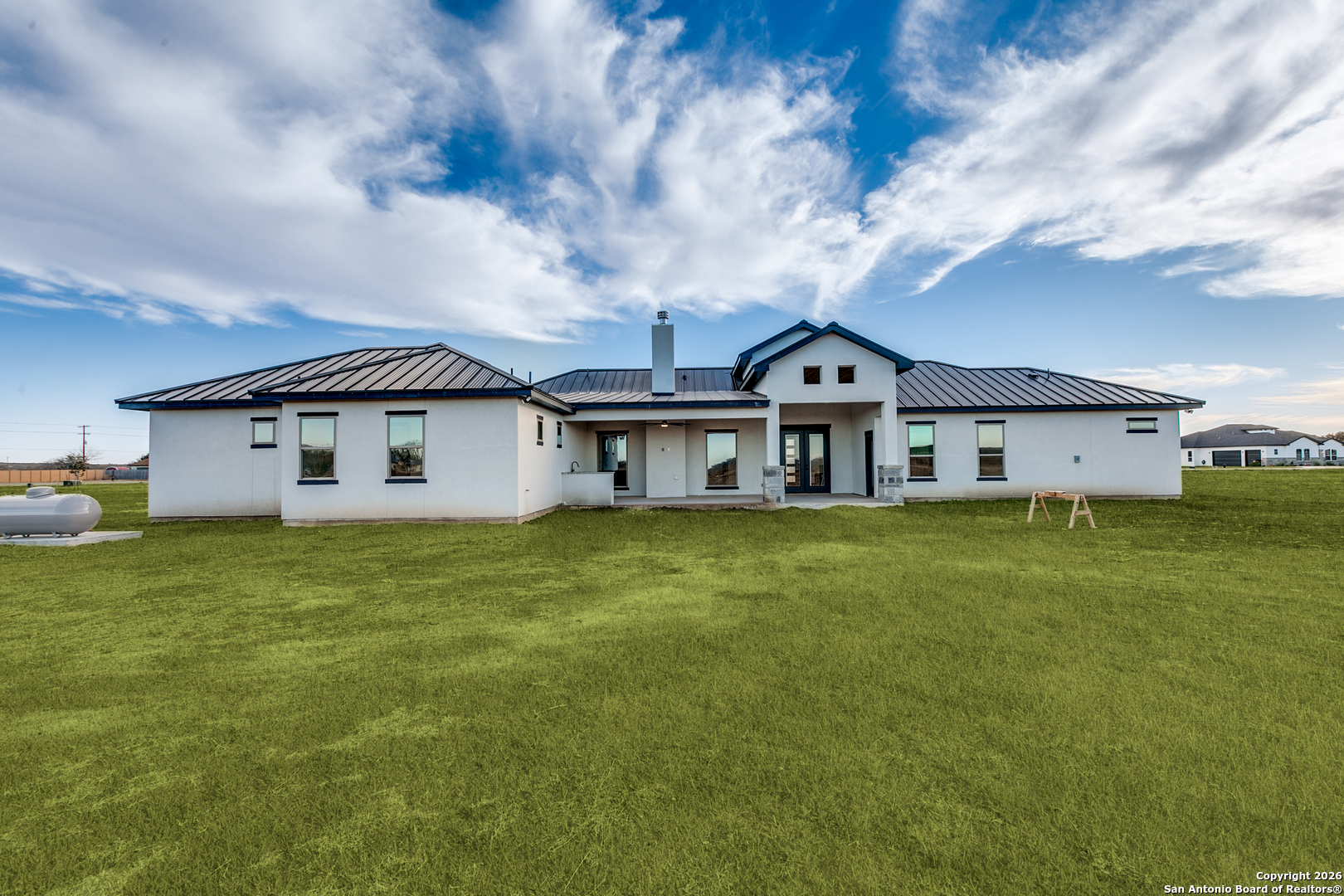 202 Venado Oaks Rio Medina, TX 78066 - Photo 33 of 37 a front view of the house with a garden