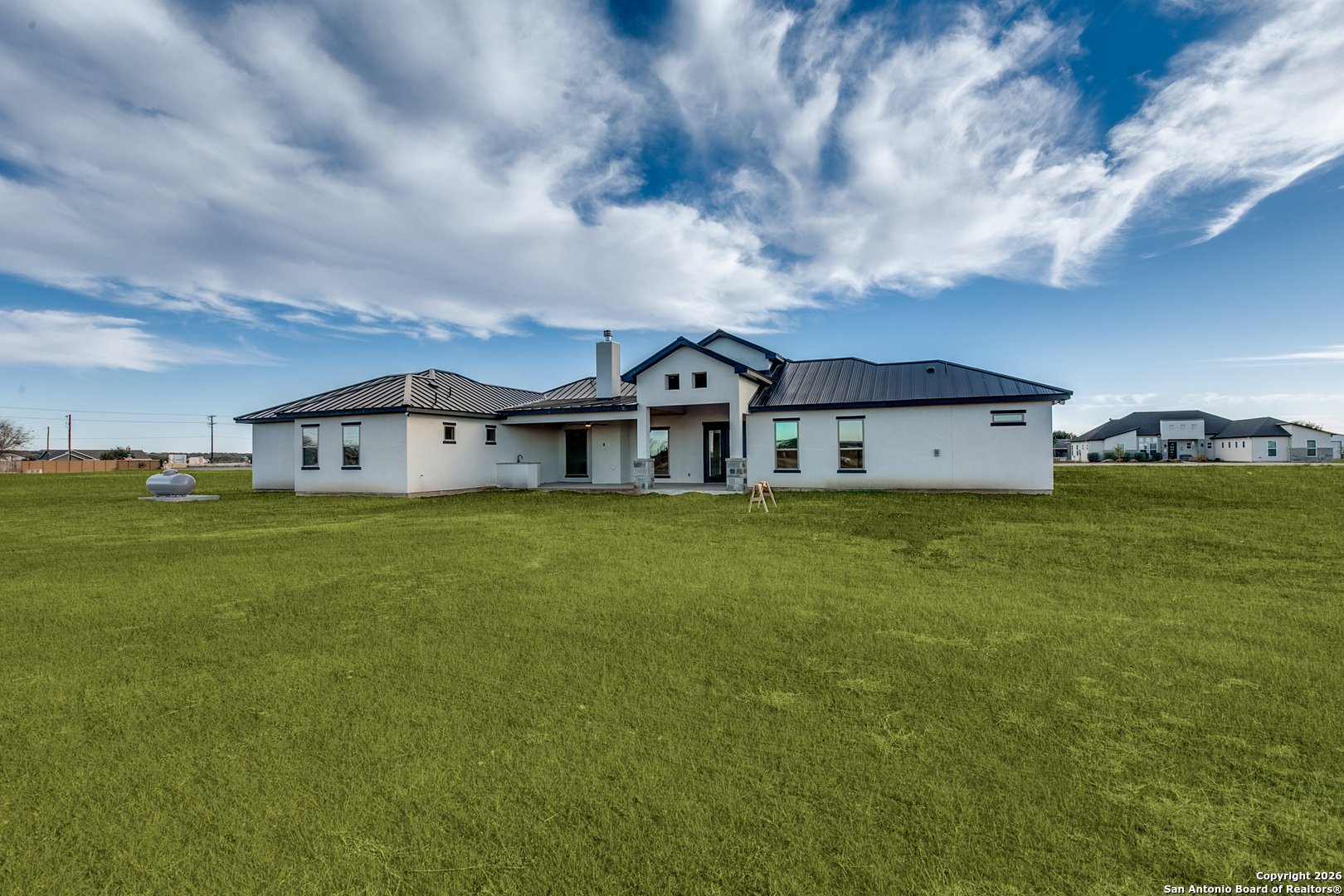 202 Venado Oaks Rio Medina, TX 78066 - Photo 34 of 37 a big house with a big yard and large trees