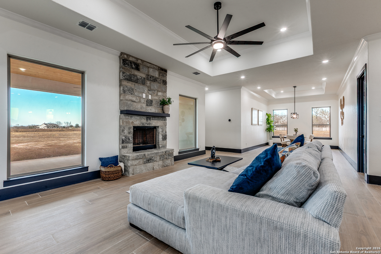 202 Venado Oaks Rio Medina, TX 78066 - Photo 10 of 37 a spacious bedroom with a large bed and a chandelier