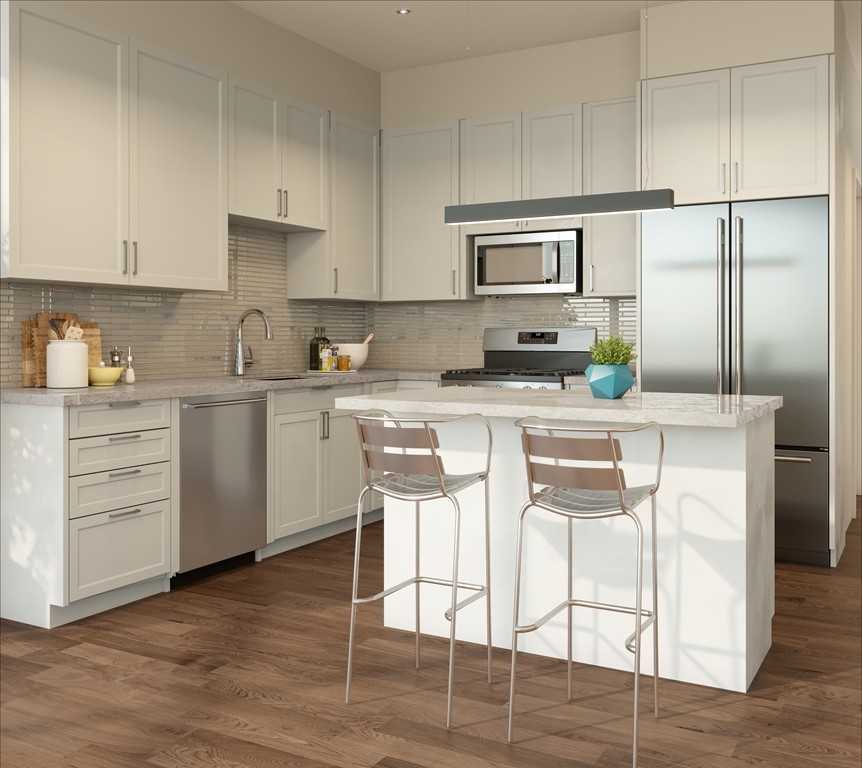 3531 Washington Street, Unit 411 Boston, MA 02130 - Photo 6 of 7 a kitchen with stainless steel appliances kitchen island granite countertop a refrigerator a stove a sink and white cabinets with wooden floor