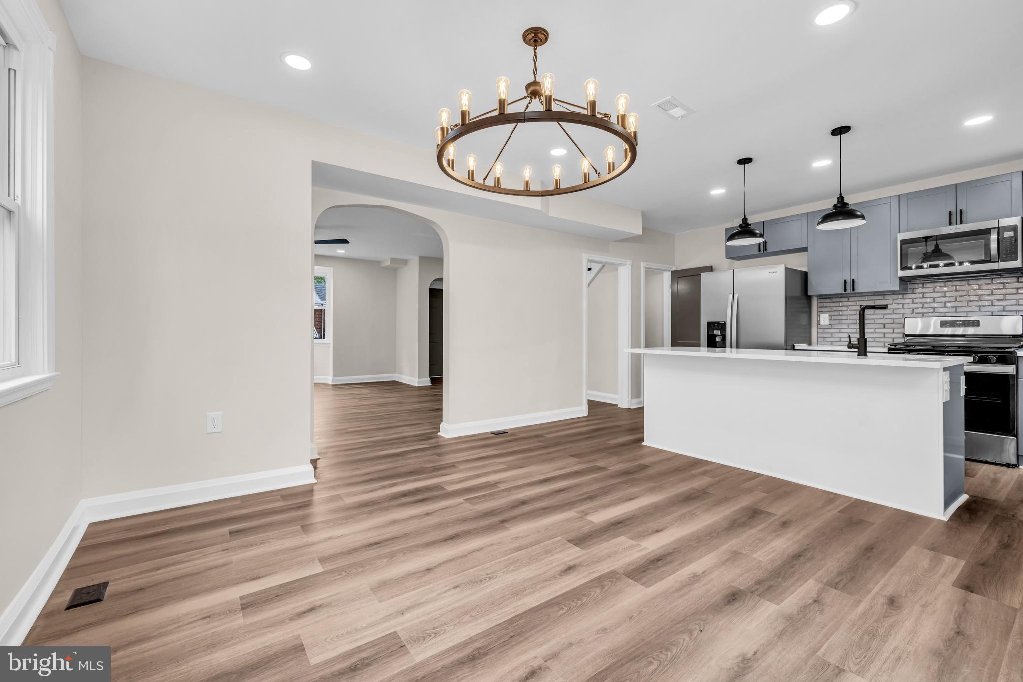 1513 Kingsway Road Baltimore, MD 21218 - Photo 2 of 47 dining with chandelier, open kitchen area
