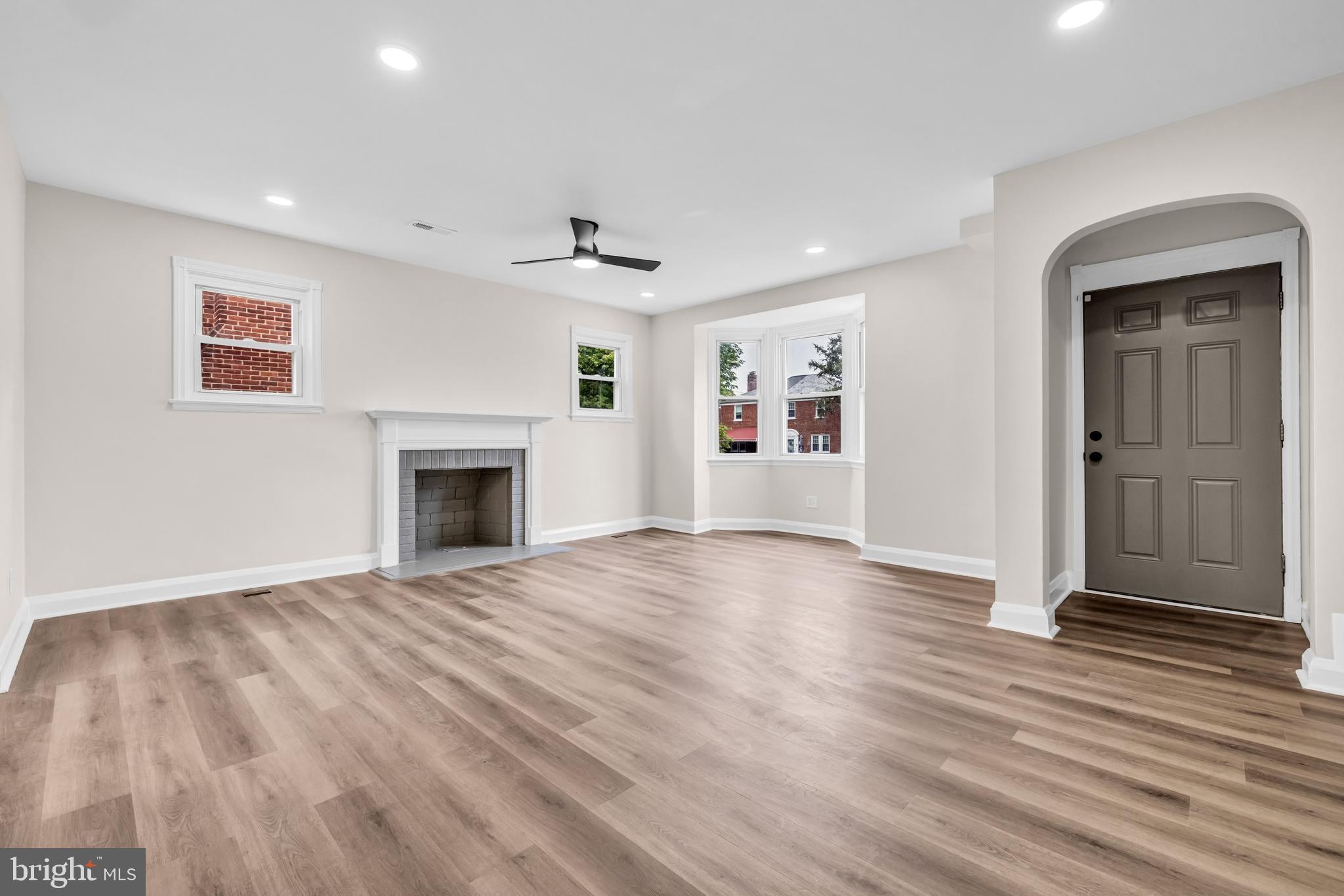 1513 Kingsway Road Baltimore, MD 21218 - Photo 3 of 47 living room with brick fire place a bay window are