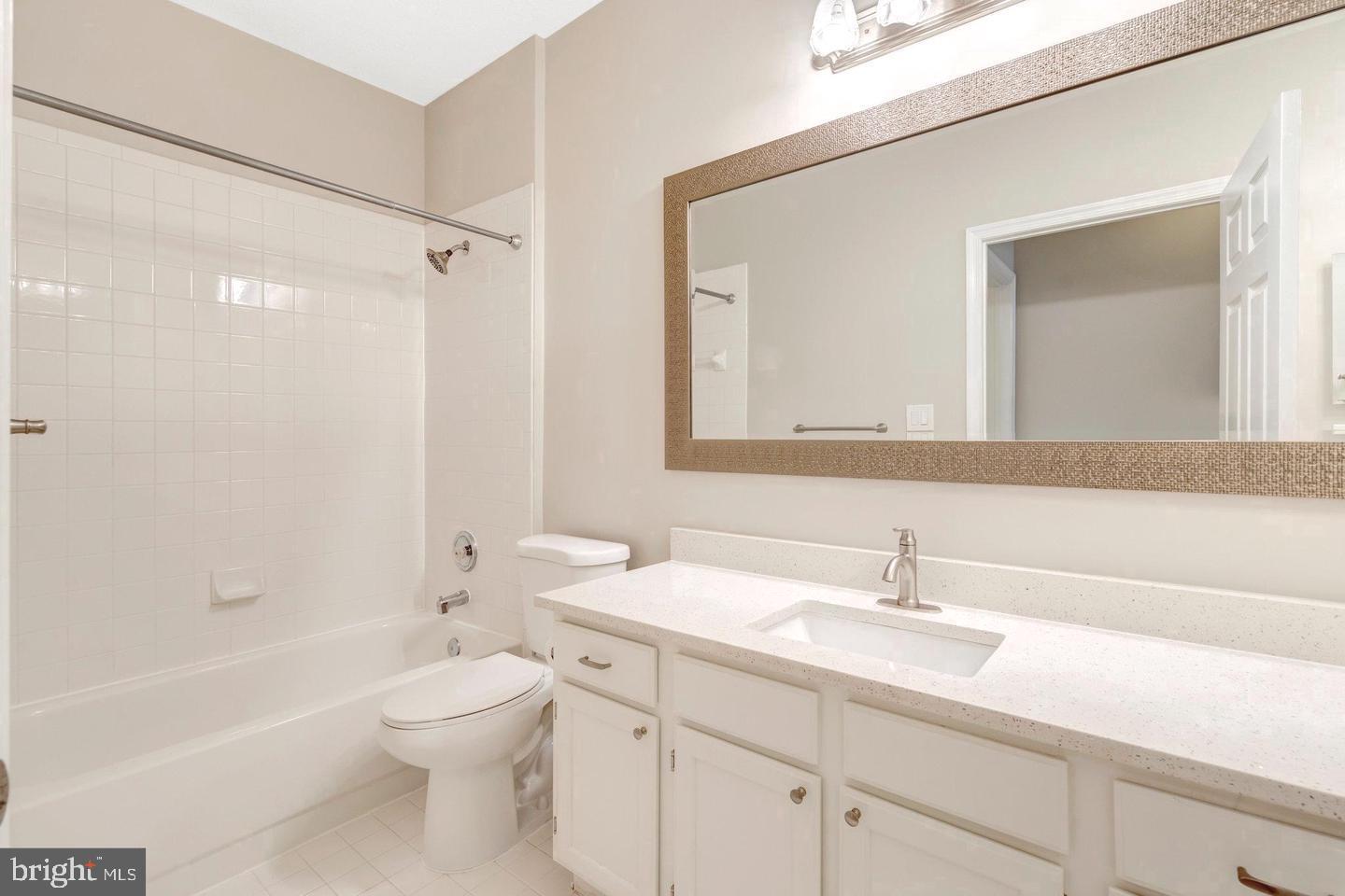 1701 Lake Shore Crest Drive, Unit 11 Reston, VA 20190 - Photo 11 of 33 a bathroom with a sink a toilet and a bathtub