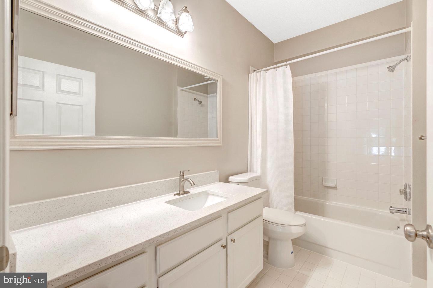 1701 Lake Shore Crest Drive, Unit 11 Reston, VA 20190 - Photo 12 of 33 a bathroom with a sink a toilet and shower
