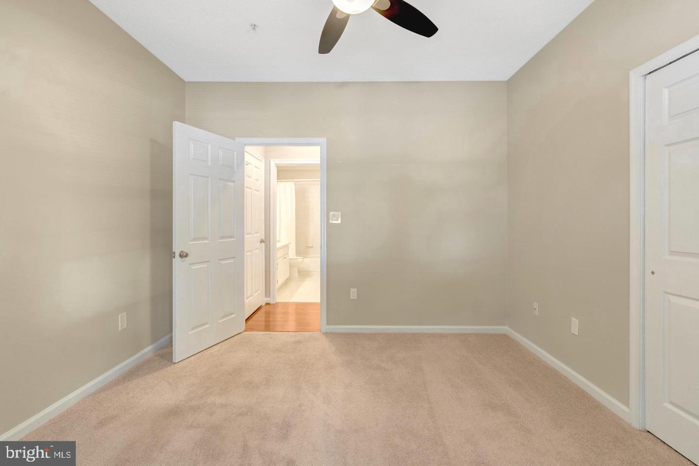 1701 Lake Shore Crest Drive, Unit 11 Reston, VA 20190 - Photo 16 of 33 an empty room with ceiling fan and window