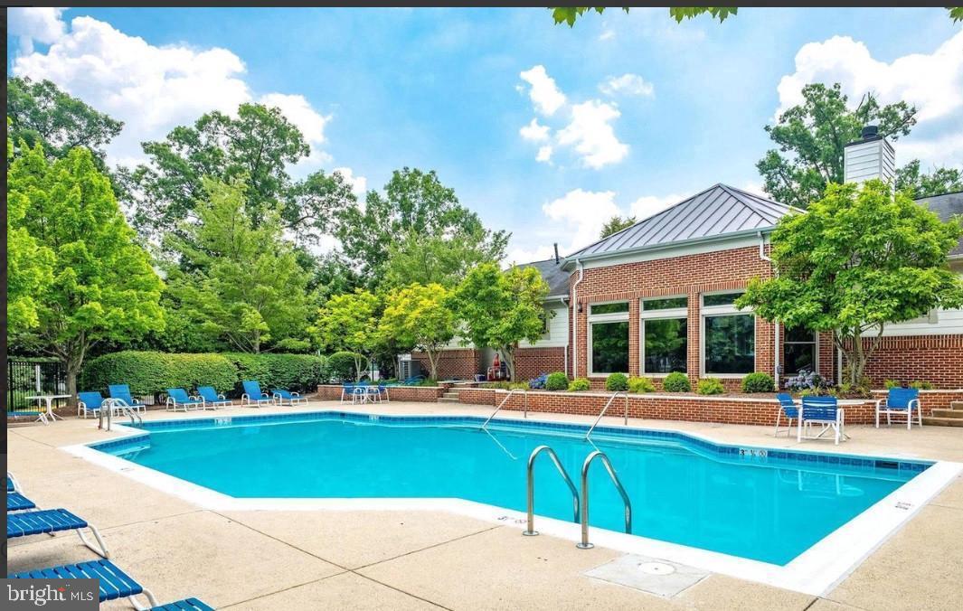 1701 Lake Shore Crest Drive, Unit 11 Reston, VA 20190 - Photo 17 of 33 a view of a swimming pool with a lounge chairs
