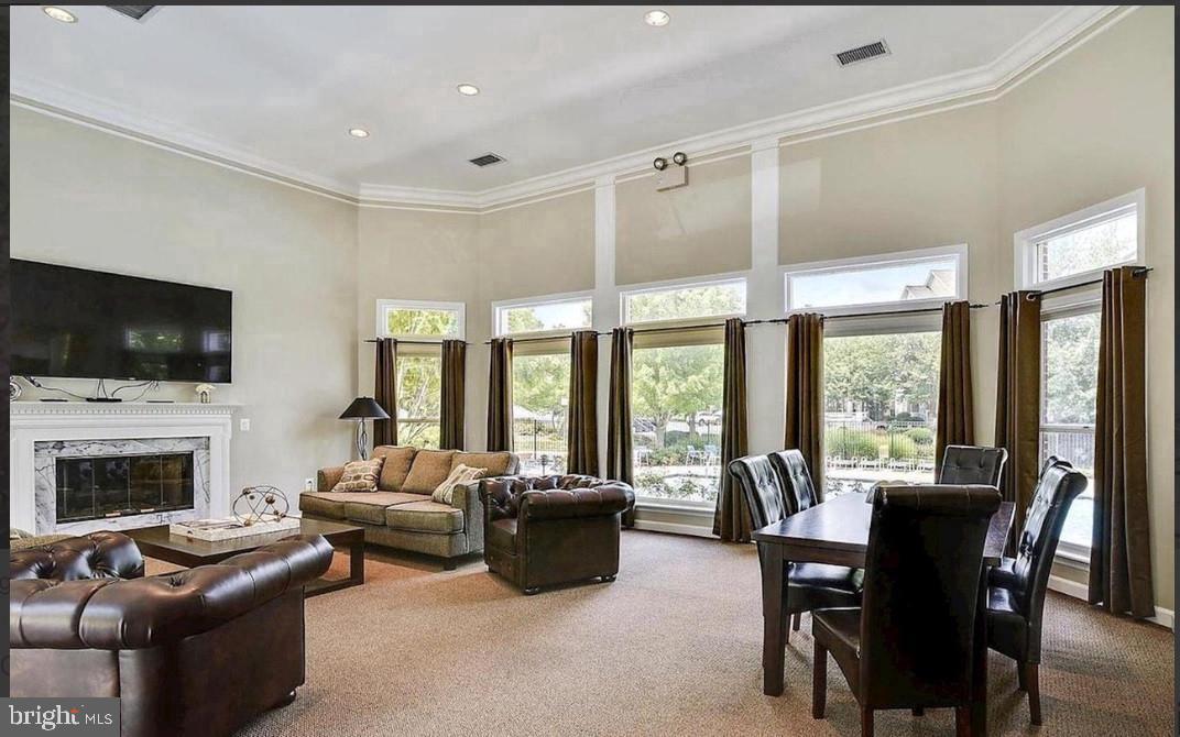 1701 Lake Shore Crest Drive, Unit 11 Reston, VA 20190 - Photo 18 of 33 a living room with furniture fireplace and a flat screen tv