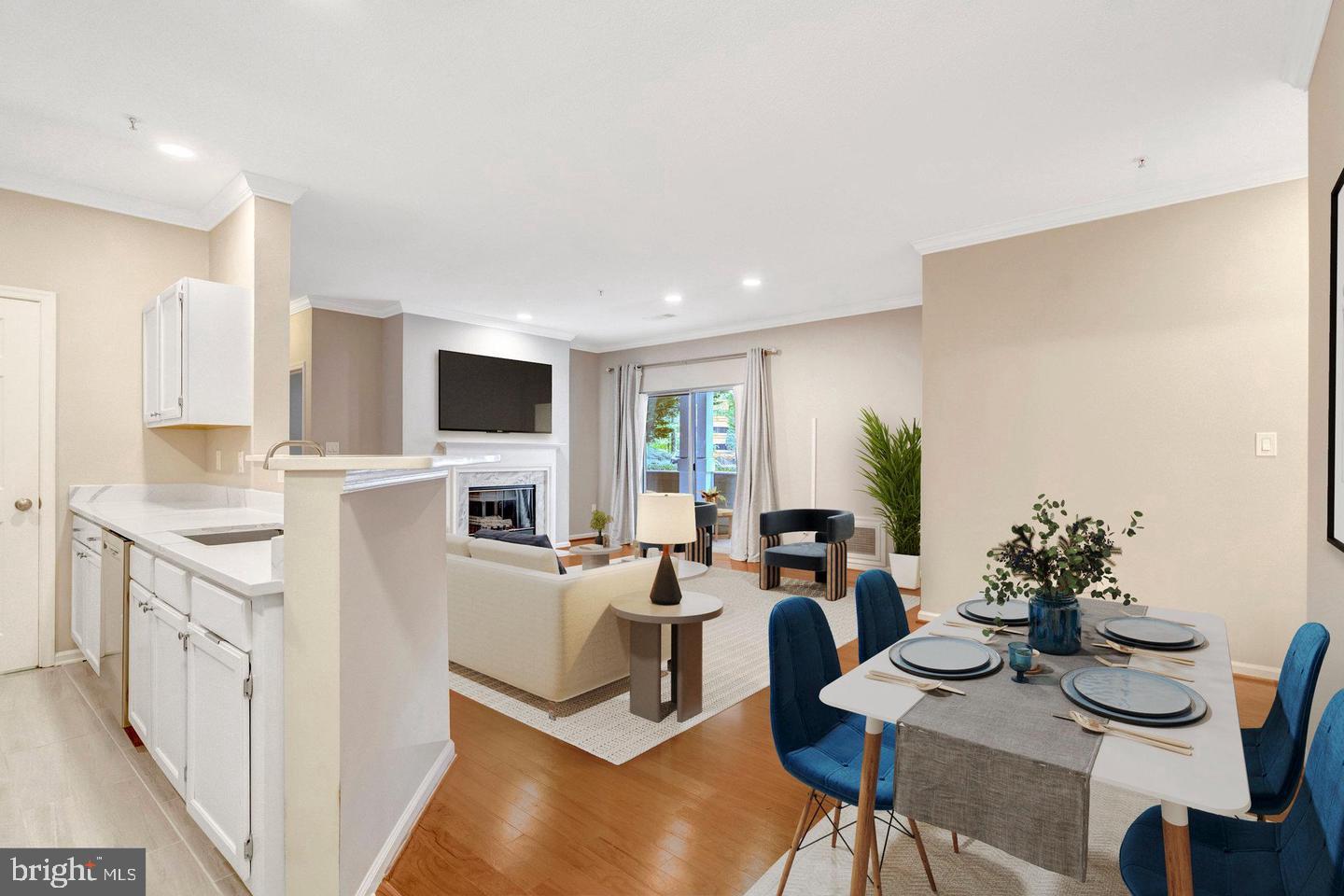 1701 Lake Shore Crest Drive, Unit 11 Reston, VA 20190 - Photo 2 of 33 a living room with furniture a flat screen tv and a refrigerator