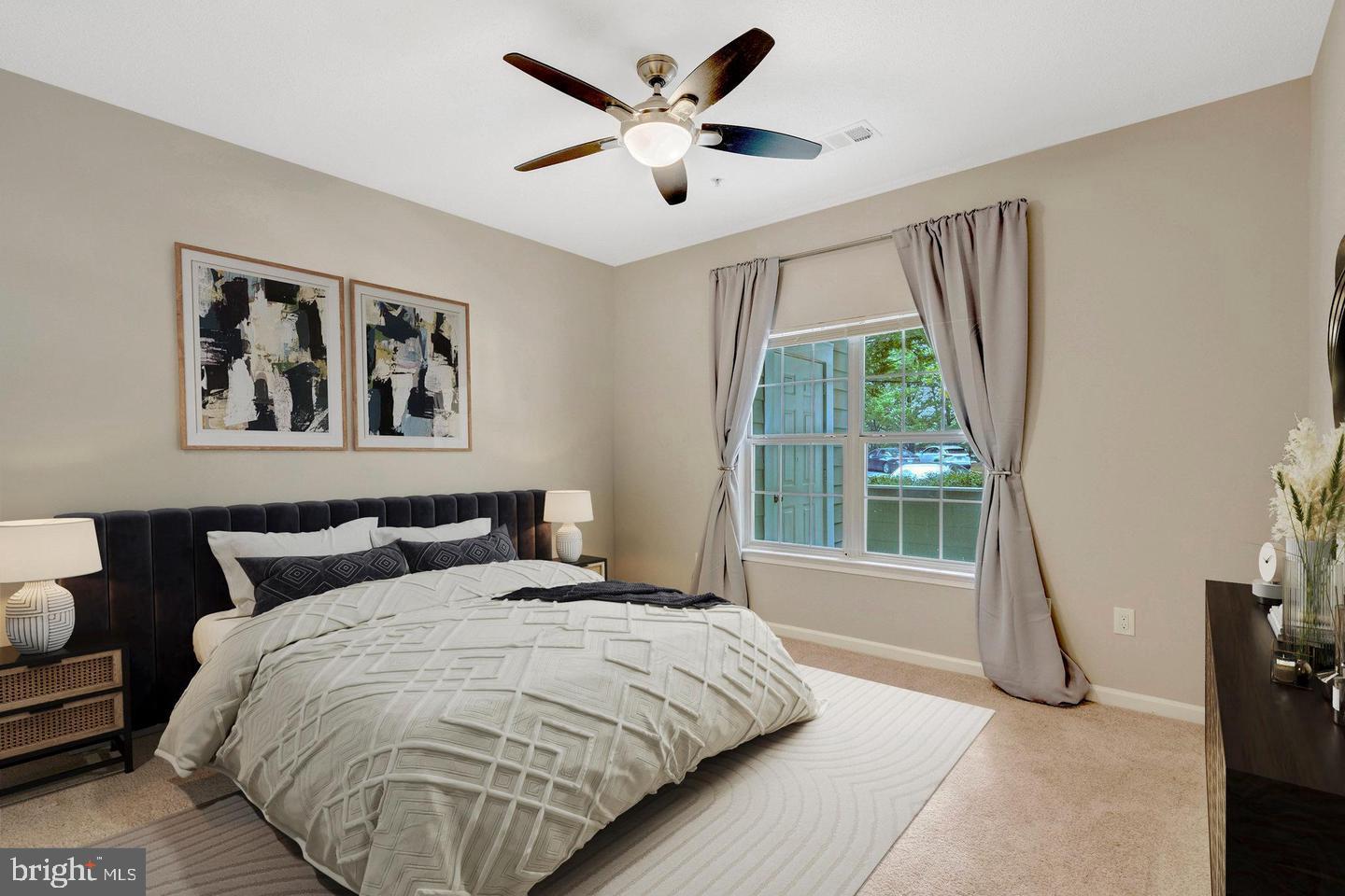 1701 Lake Shore Crest Drive, Unit 11 Reston, VA 20190 - Photo 4 of 33 a bedroom with a large bed and a large window