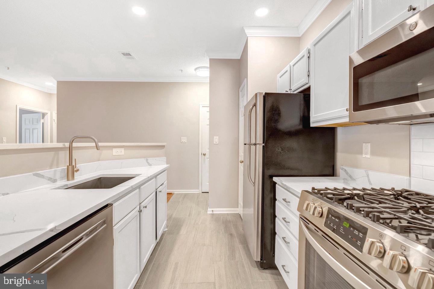 1701 Lake Shore Crest Drive, Unit 11 Reston, VA 20190 - Photo 6 of 33 a kitchen with a sink stove and refrigerator
