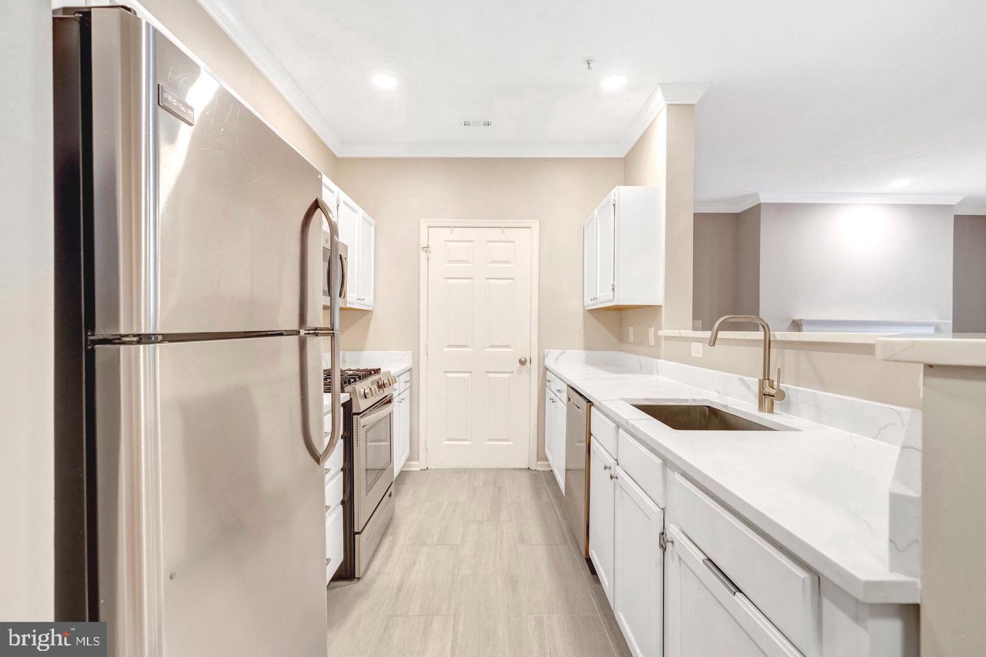 1701 Lake Shore Crest Drive, Unit 11 Reston, VA 20190 - Photo 7 of 33 a kitchen with a sink a refrigerator and a sink
