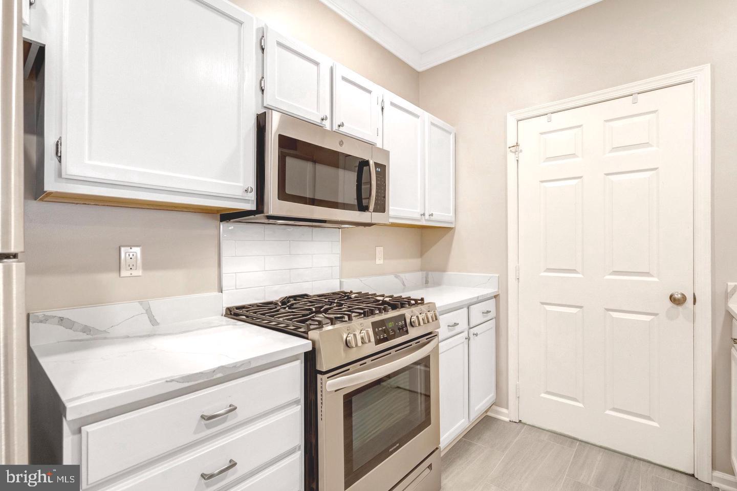 1701 Lake Shore Crest Drive, Unit 11 Reston, VA 20190 - Photo 8 of 33 a kitchen with stainless steel appliances white cabinets and stove