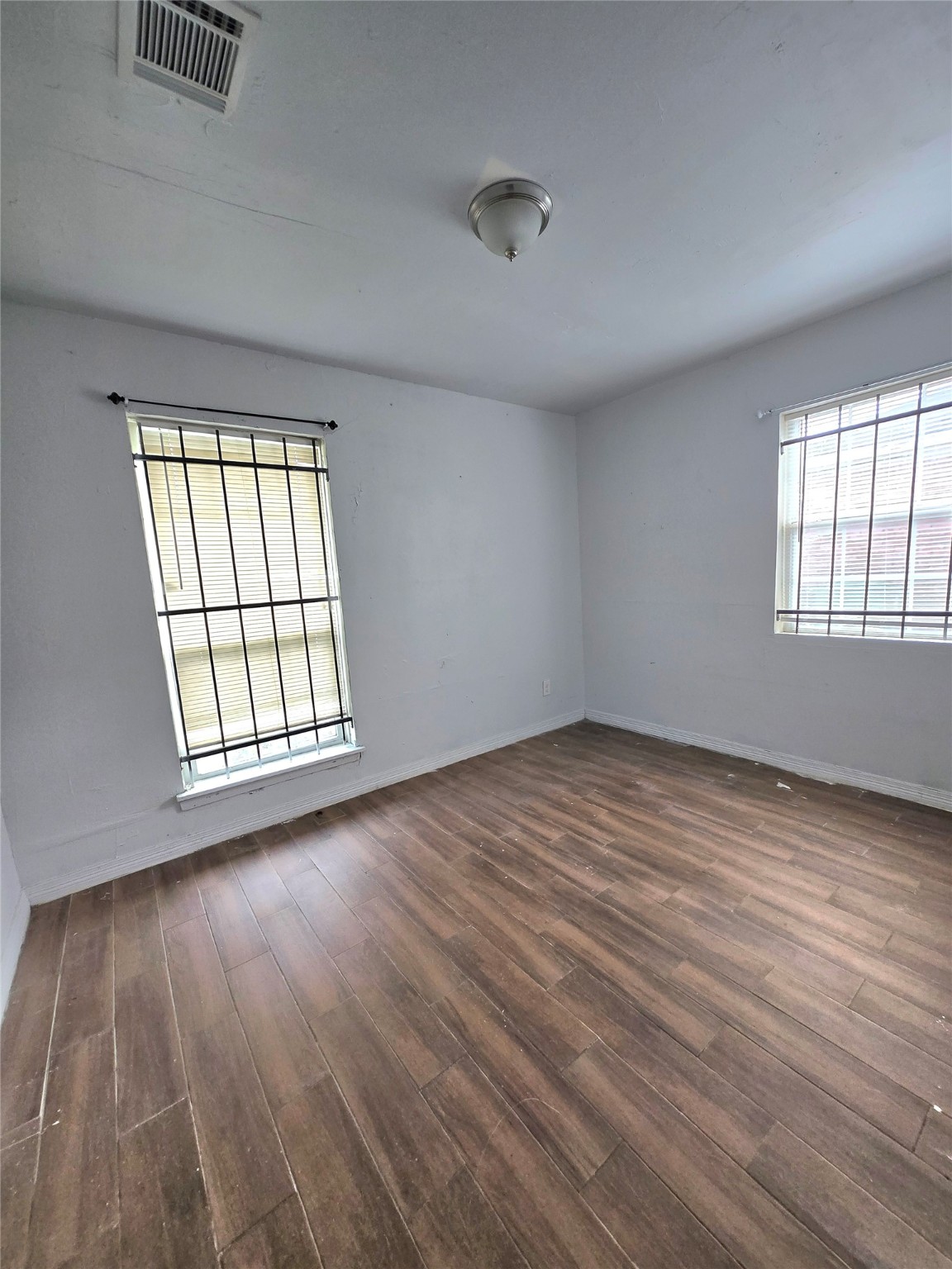 5530 Elm Spring Drive Houston, TX 77048 - Photo 11 of 15 an empty room with wooden floor and windows