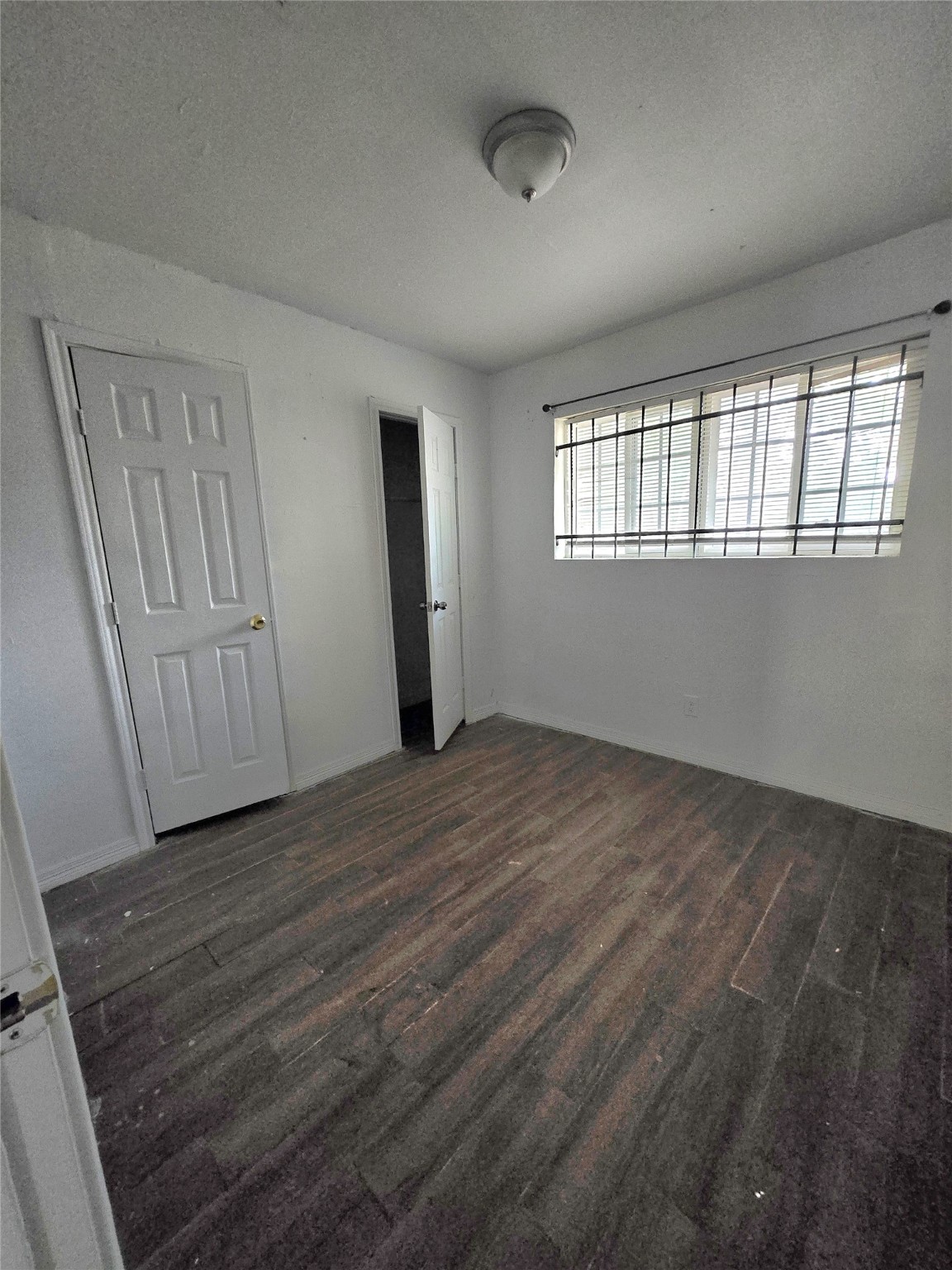 5530 Elm Spring Drive Houston, TX 77048 - Photo 13 of 15 an empty room with wooden floor and windows