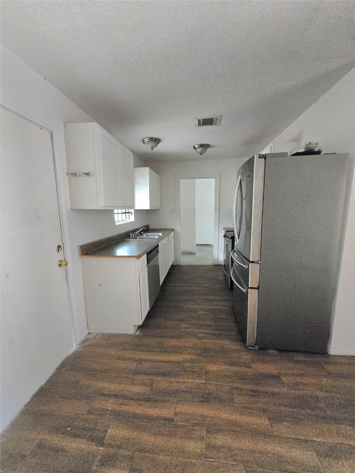 5530 Elm Spring Drive Houston, TX 77048 - Photo 15 of 15 a view of a kitchen with a sink and refrigerator