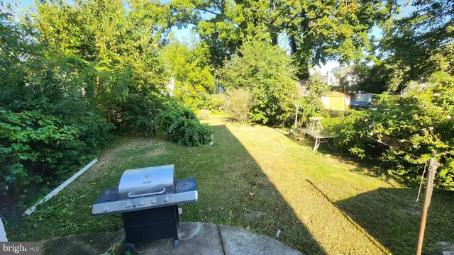 a view of yard from deck having outdoor seating