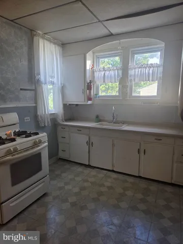 a kitchen with a sink stove and cabinets