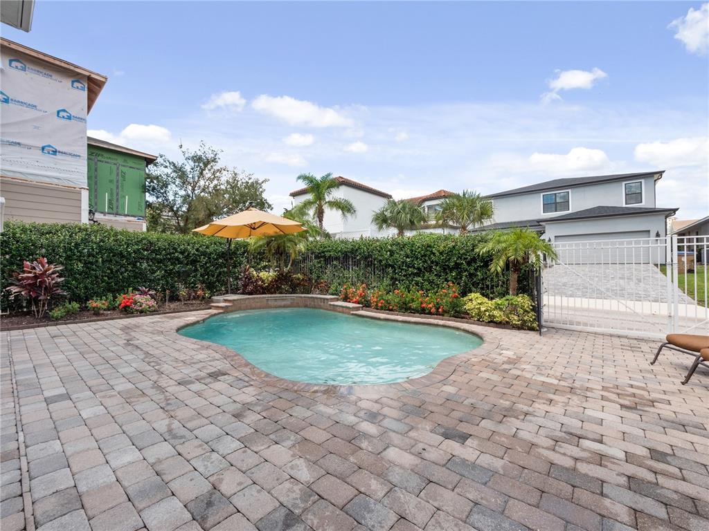1208 Radiant Street Reunion, FL 34747 - Photo 20 of 47 a front view of a house with a yard and garage