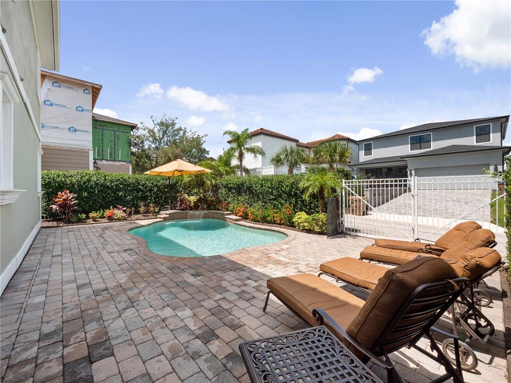 1208 Radiant Street Reunion, FL 34747 - Photo 23 of 47 a view of a patio with couches table and chairs and potted plants