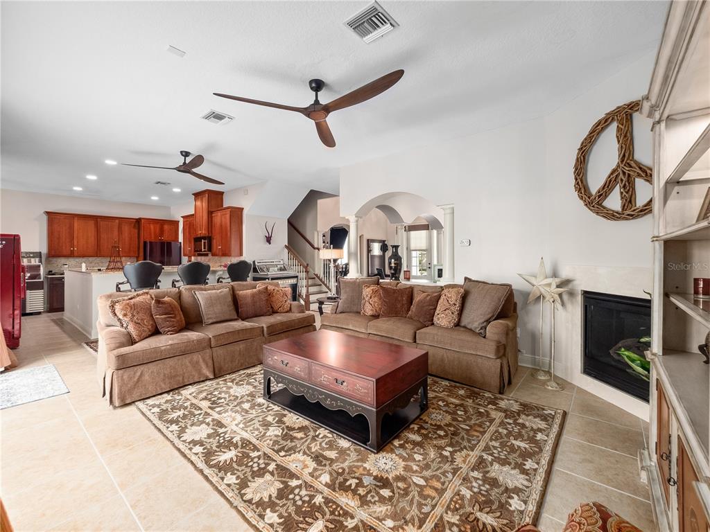 1208 Radiant Street Reunion, FL 34747 - Photo 3 of 47 a living room with furniture and a fireplace