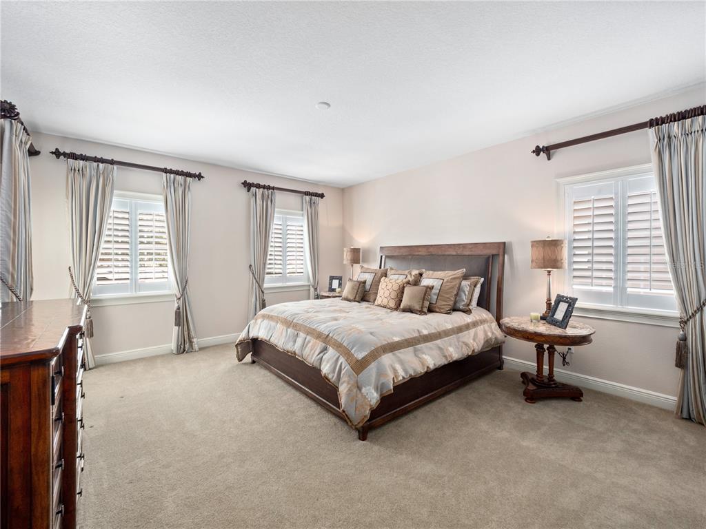 1208 Radiant Street Reunion, FL 34747 - Photo 34 of 47 a spacious bedroom with a bed and a window