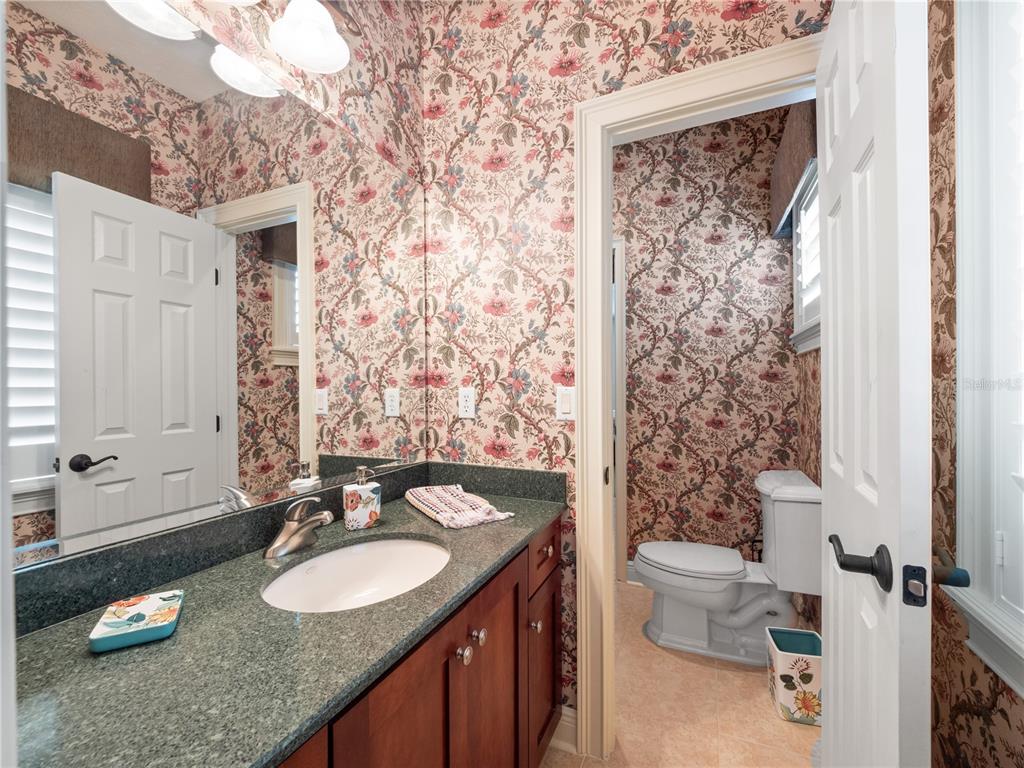 1208 Radiant Street Reunion, FL 34747 - Photo 36 of 47 a bathroom with a granite countertop sink toilet and shower