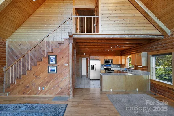 a kitchen with stainless steel appliances granite countertop a stove a refrigerator and a sink