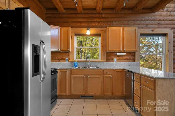 a kitchen with stainless steel appliances granite countertop a sink a stove and a microwave