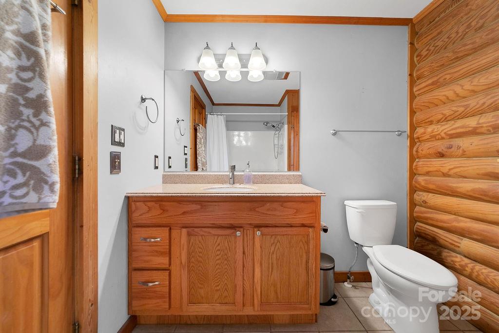 85 Ridge Road Rosman, NC 28772 - Photo 19 of 48 a bathroom with a granite countertop toilet sink and mirror