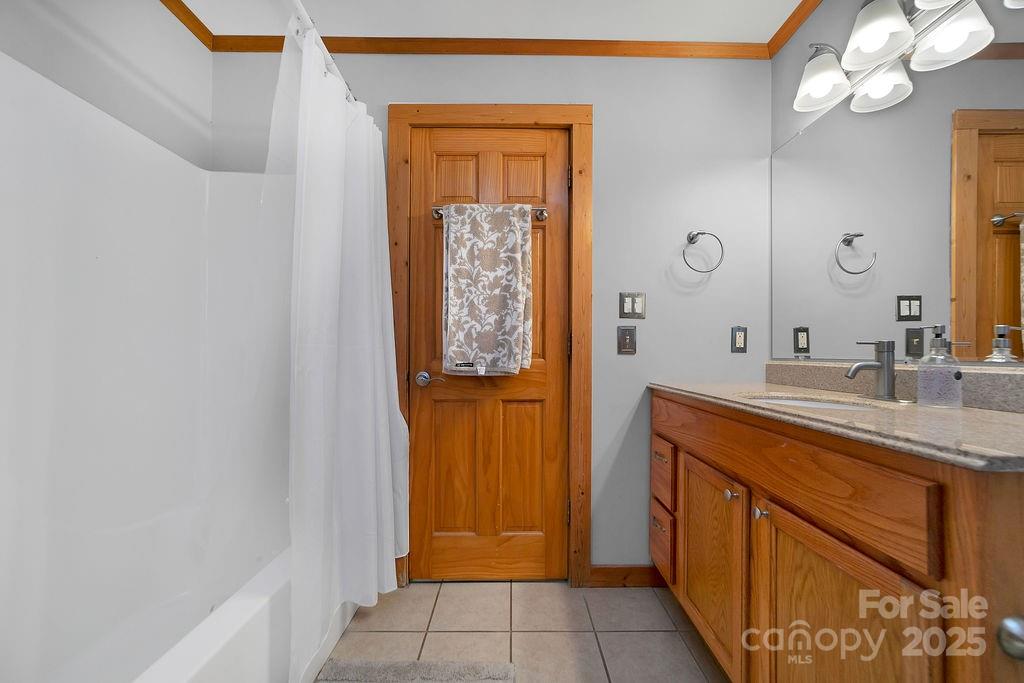 85 Ridge Road Rosman, NC 28772 - Photo 20 of 48 a bathroom with a sink a mirror and a shower
