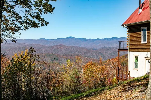 a view of a house with a mountain in the background