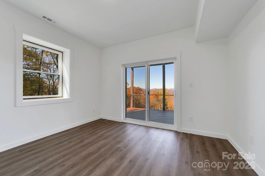 85 Ridge Road Rosman, NC 28772 - Photo 36 of 48 a view of an empty room with wooden floor and a window