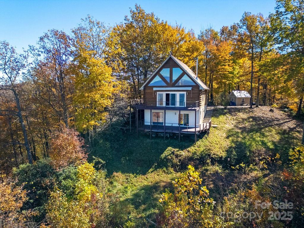 85 Ridge Road Rosman, NC 28772 - Photo 42 of 48 a front view of a house with a yard and fountain