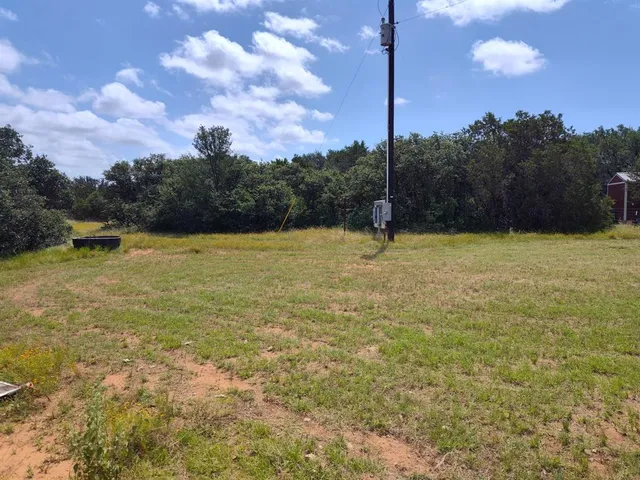 a backyard of a house with lots of green space and lake view