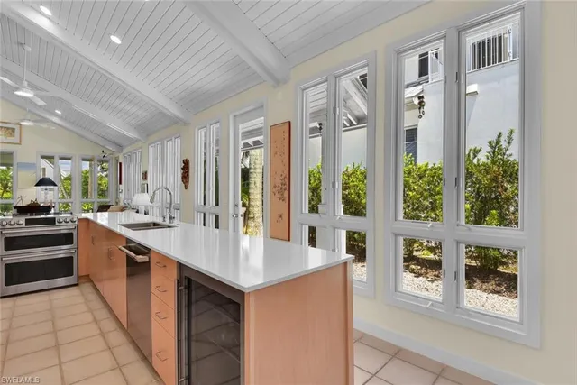 a large white kitchen with a large window