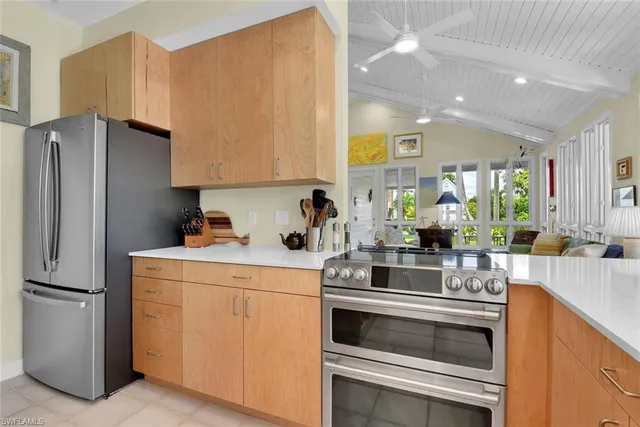 a kitchen with a sink stove and refrigerator