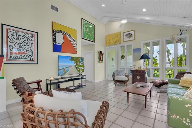 a living room with furniture and a painting on the wall