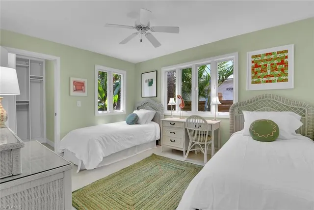 a spacious bedroom with a bed and wooden floor