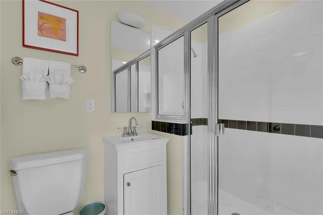 a bathroom with a sink a toilet and a shower