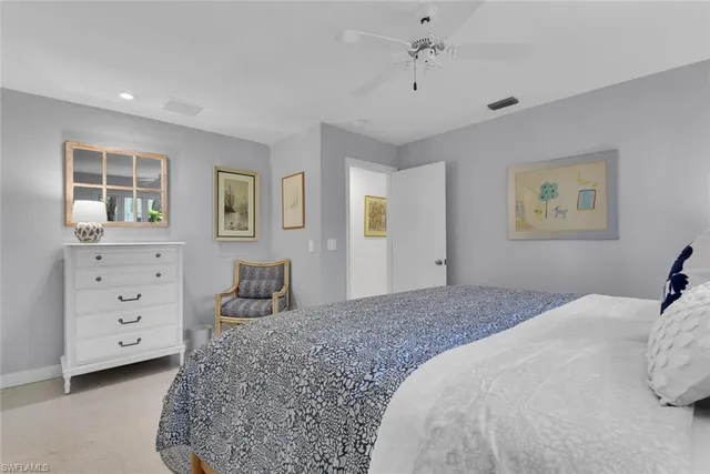 a bedroom with a large bed and a dresser