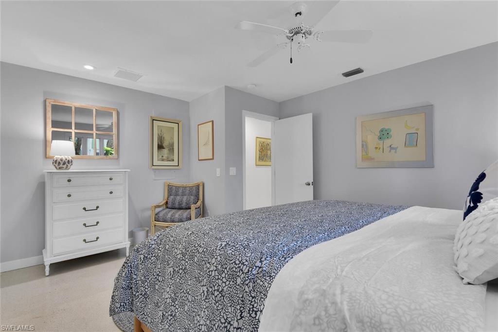 223 11th Avenue South Naples, FL 34102 - Photo 23 of 42 a bedroom with a large bed and a dresser