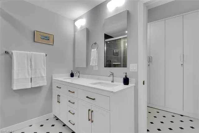 a bathroom with a sink vanity and mirror