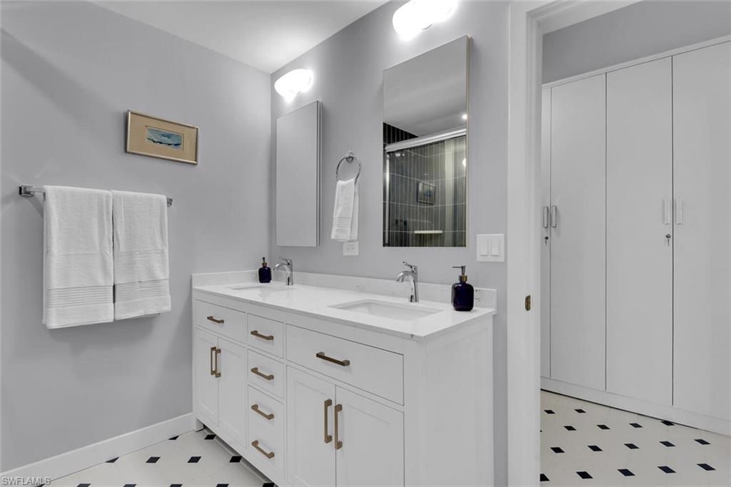 223 11th Avenue South Naples, FL 34102 - Photo 25 of 42 a bathroom with a sink vanity and mirror