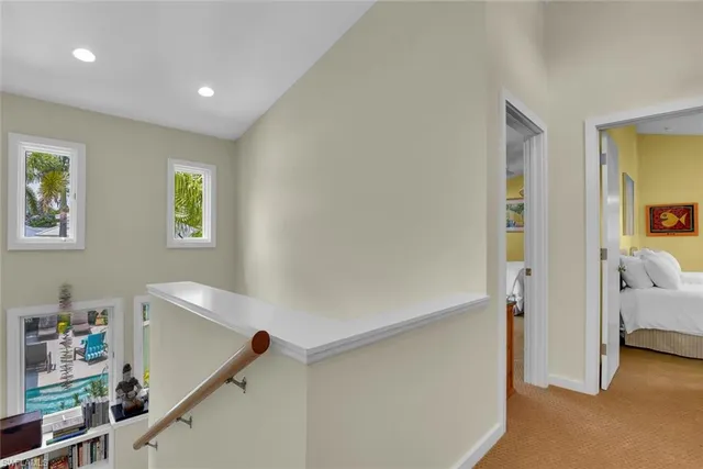 a view of hallway with livingroom and stairs
