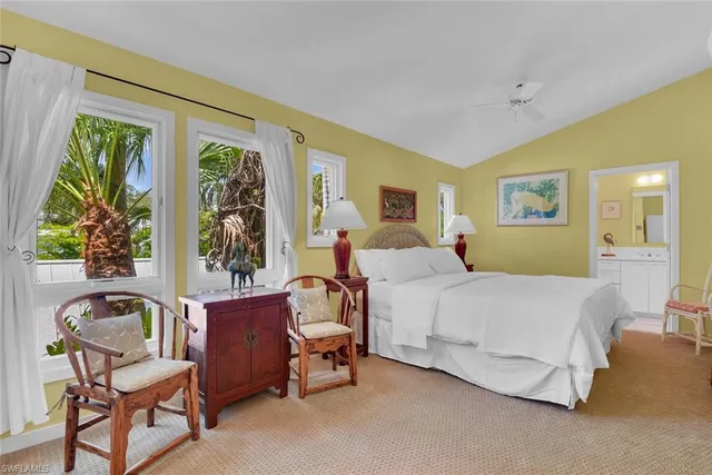 a bed room with a bed and a chair