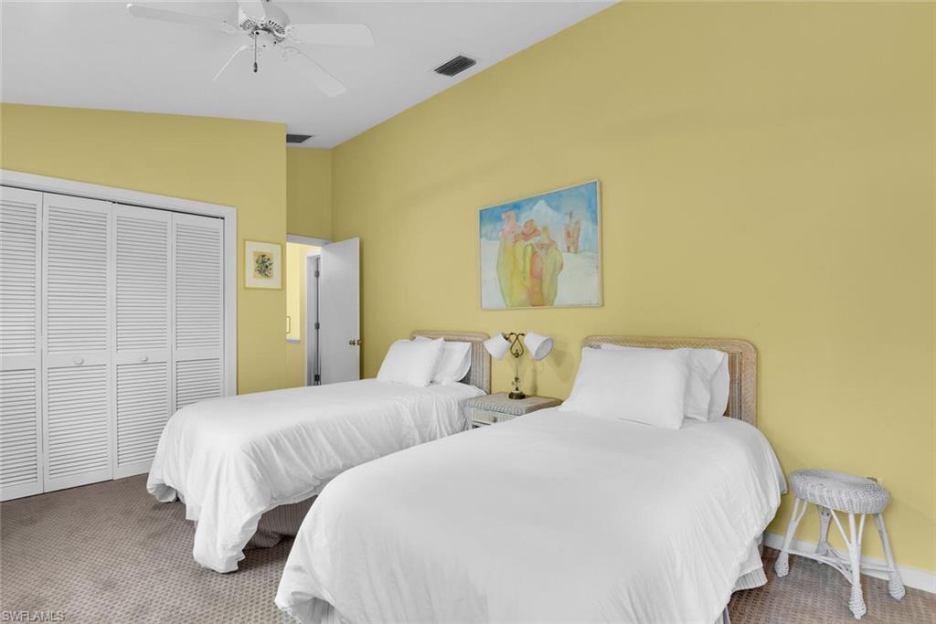 223 11th Avenue South Naples, FL 34102 - Photo 32 of 42 a bedroom with two beds and painting on the wall