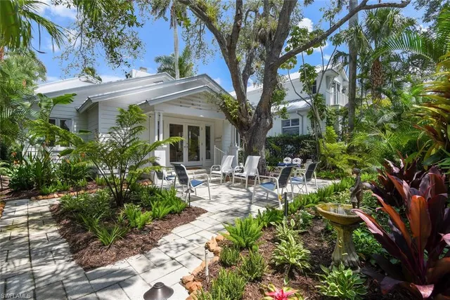 a view of a patio with table and chairs and potted plants